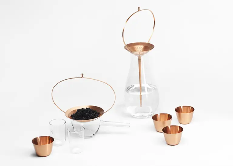 Formafantasma’s Delicately Engraved Glass and Copper ‘Still’ Vases Purify Water Using Activated Charcoal