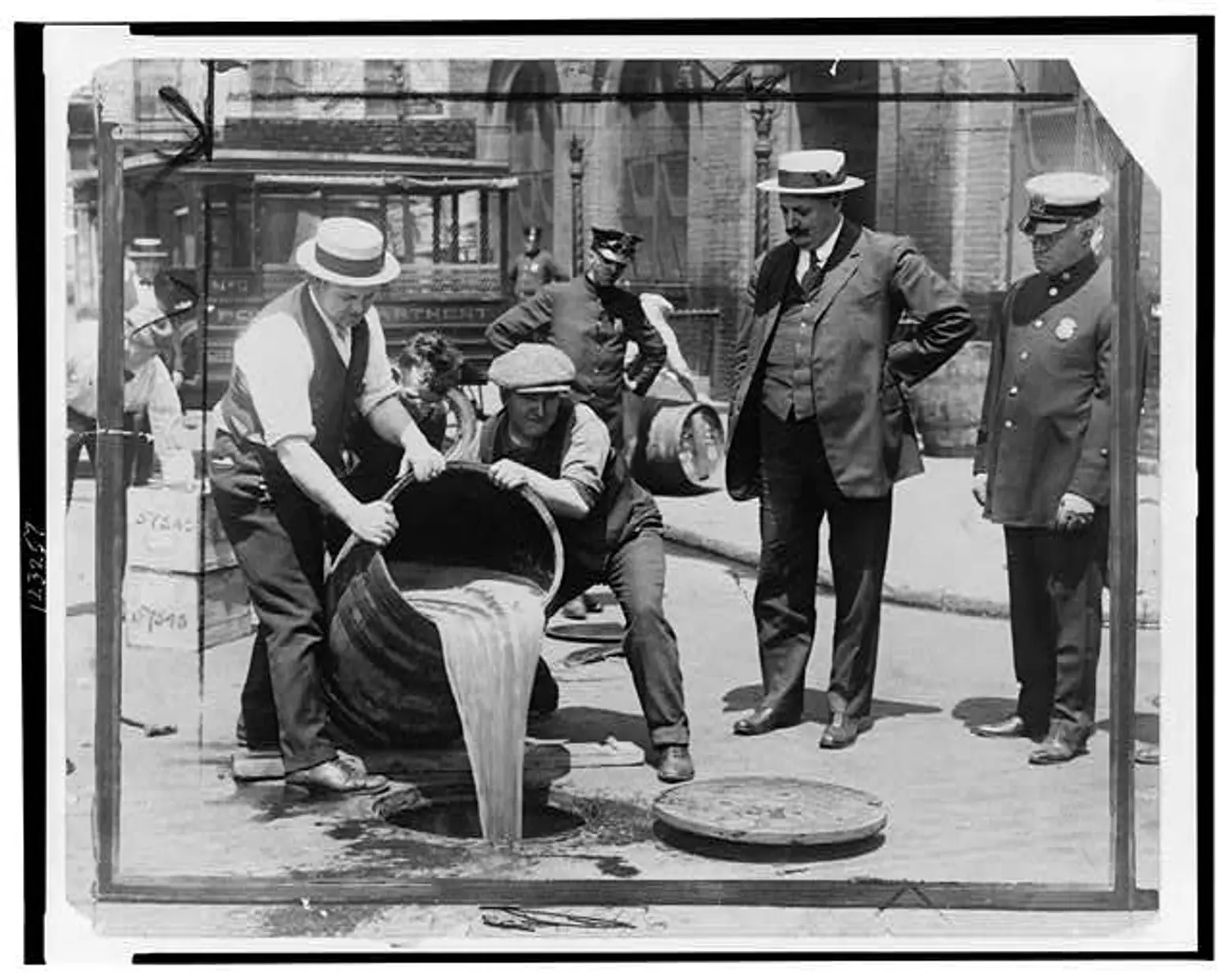 Alcohol getting poured into sewer in NYC, 1920