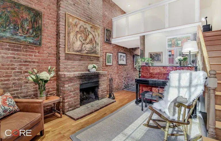 This $845K Chelsea studio’s sleep loft, brick walls and terrace are dreamy