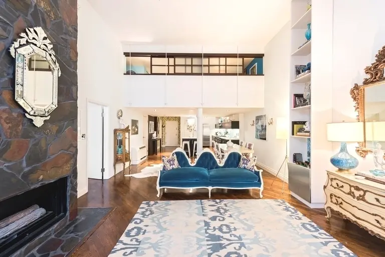 A grand fireplace and double-height ceilings at this $2.4M Chelsea condo