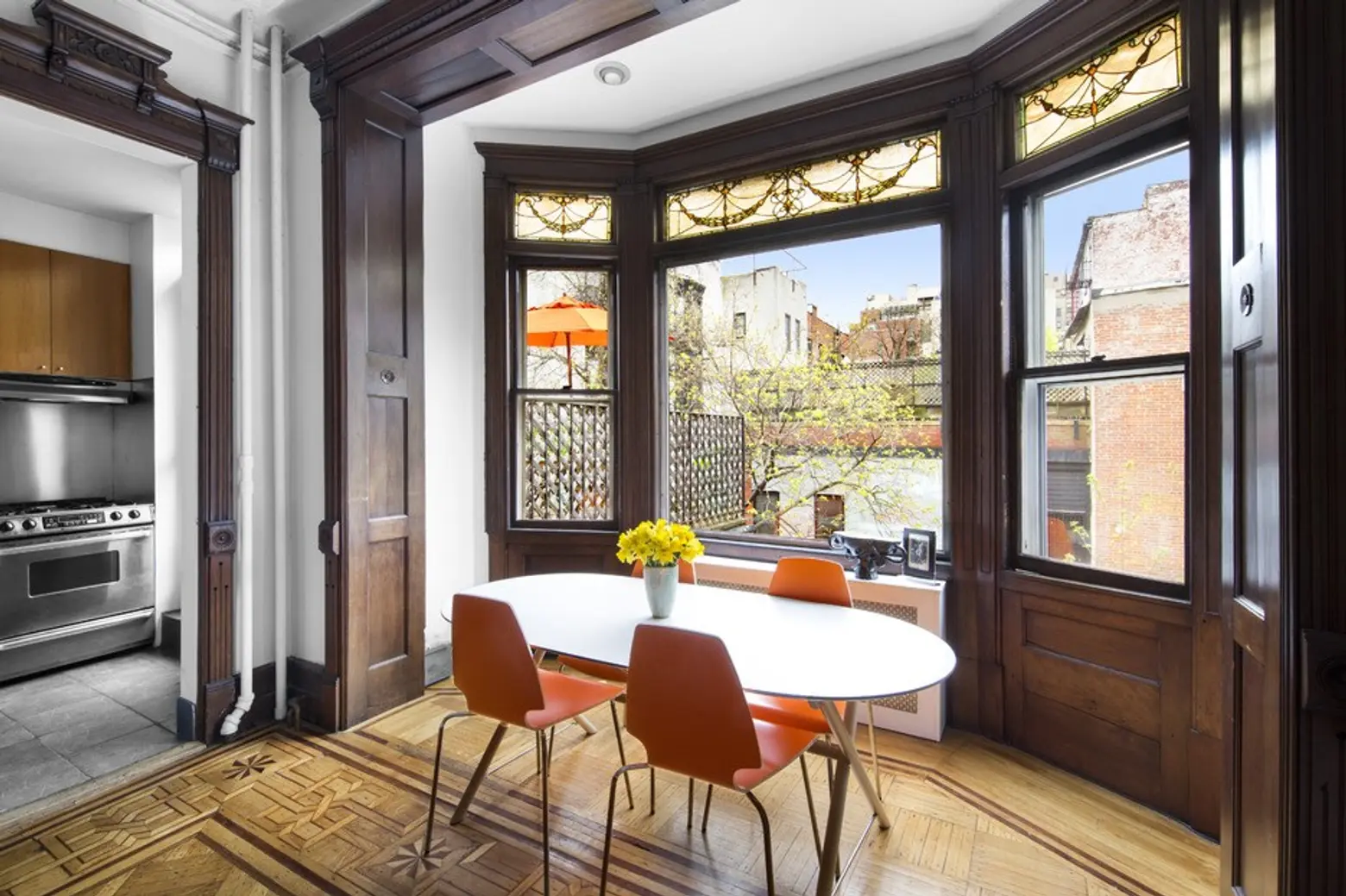 $1.095M duplex in a Park Slope brownstone boasts intricate stained glass and inlaid wood floors