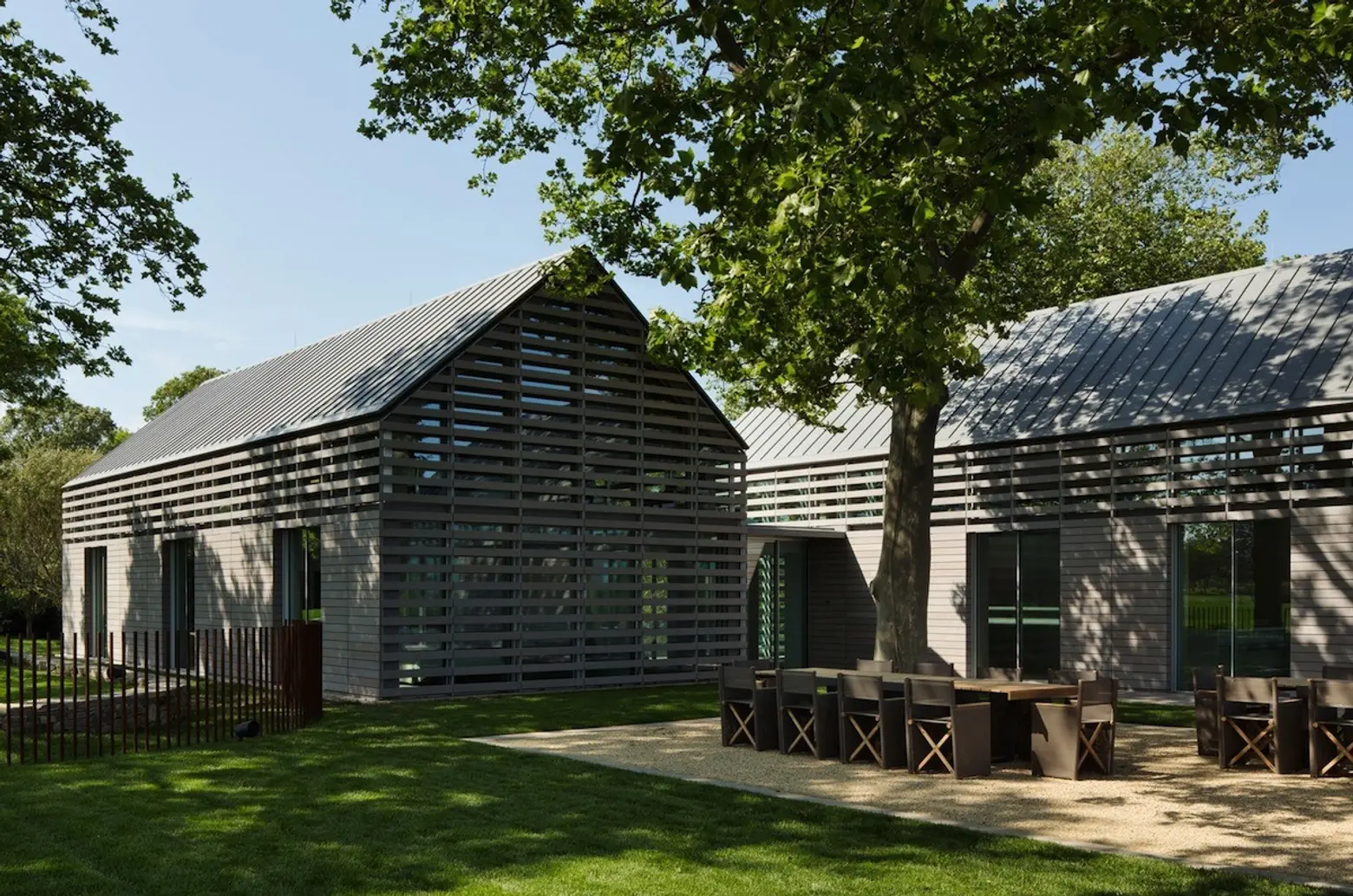 Wood slat-covered glass volumes create an elegant interior at this Hamptons guest home