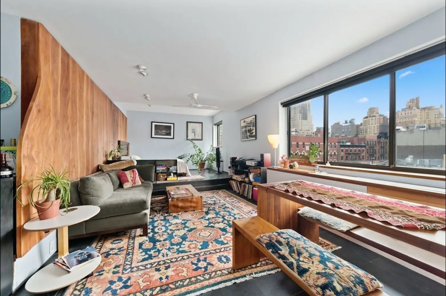 This little Chelsea studio with cool custom details and a stunning wood wall is asking $589K