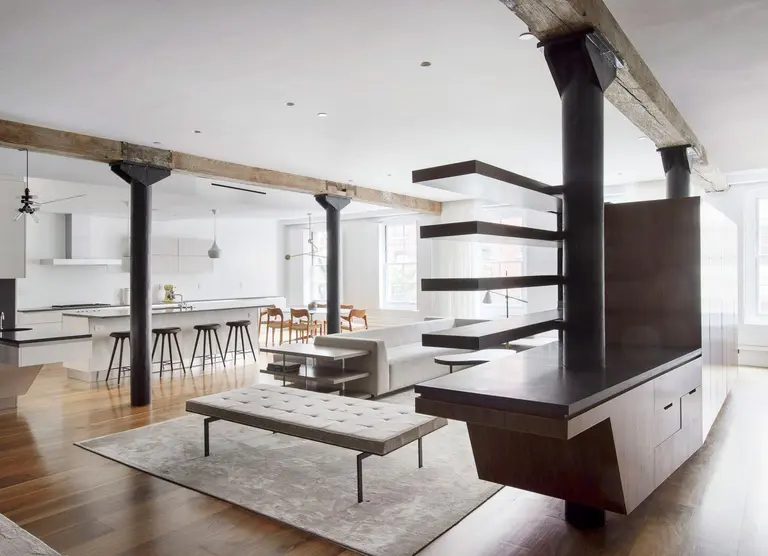Office of Architecture replaced walls with walnut cabinetry and sliding doors in this Tribeca reno