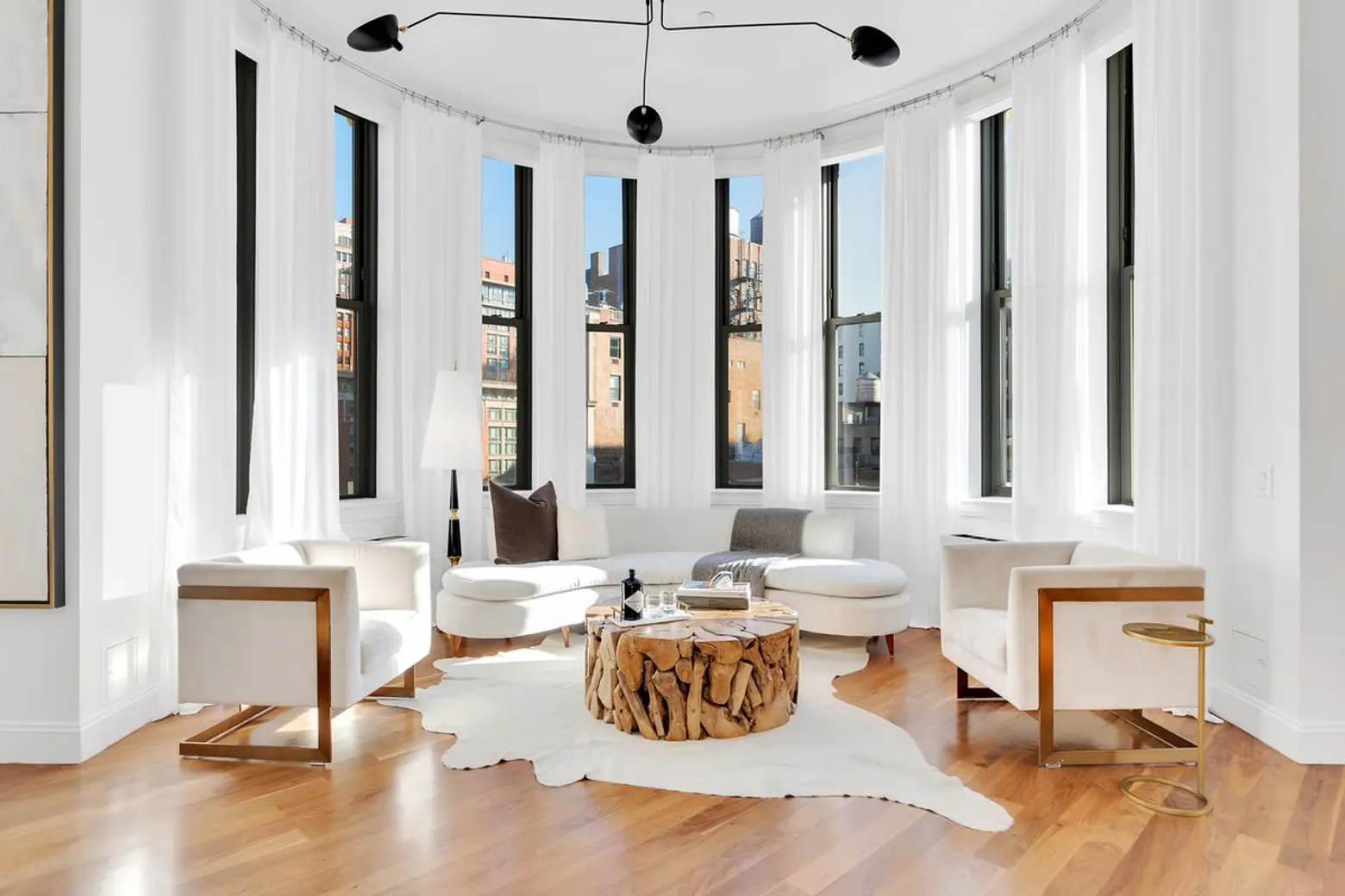 Window-wrapped turrets offer three-way views in this $6M Chelsea aerie