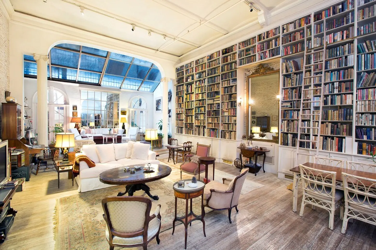 $2.7M Noho triplex stuns with library walls, glass ceilings, and gilded mirrors