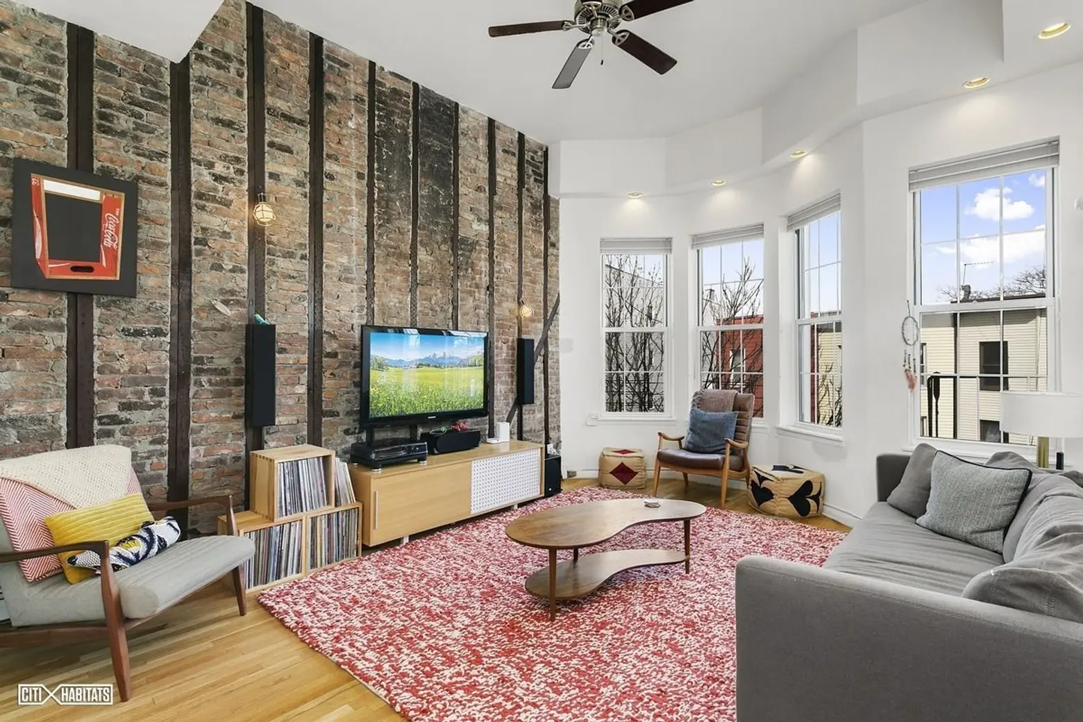 Old and new meet at this $1.4M Greenpoint duplex with brick feature wall and glass-enclosed staircase