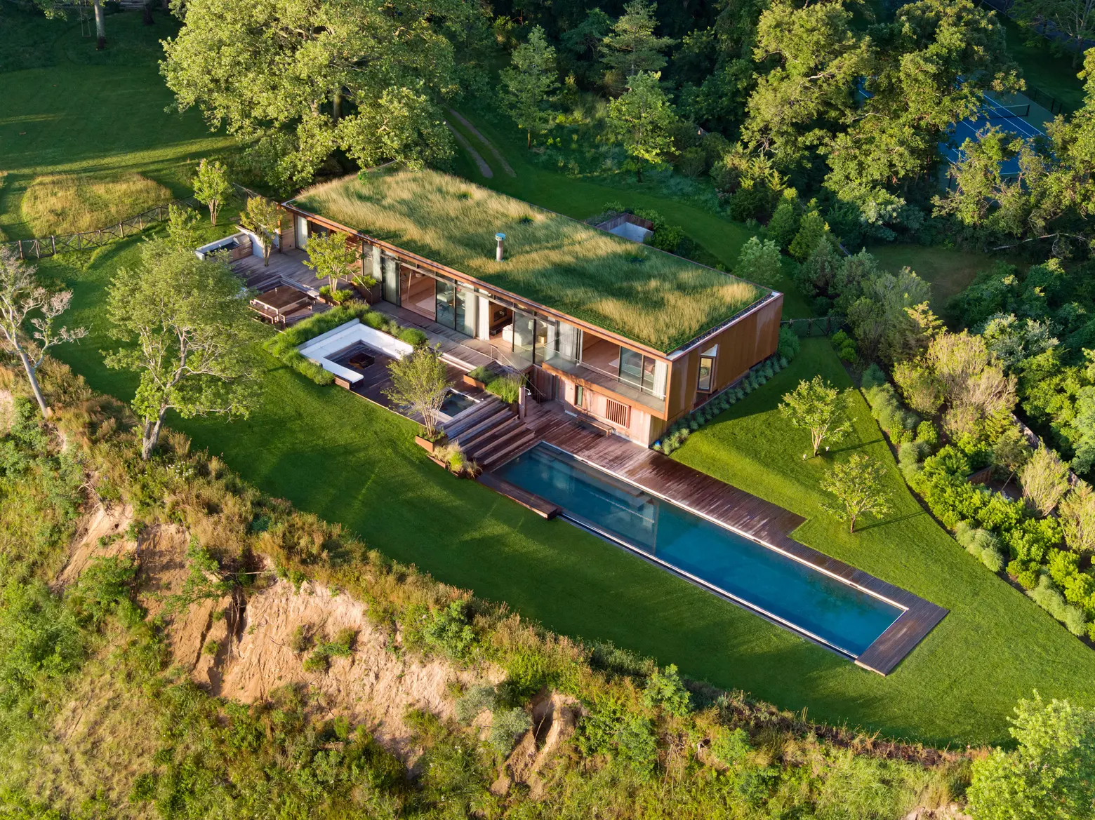 At this five-acre Hamptons getaway, a grass roof and infinity pool camouflage with the landscape