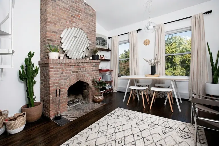 A big brick fireplace warms up this $900K Boerum Hill apartment