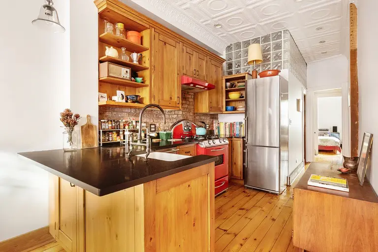 $830K Cobble Hill co-op has a colorful retro kitchen, a clawfoot tub, and a private backyard