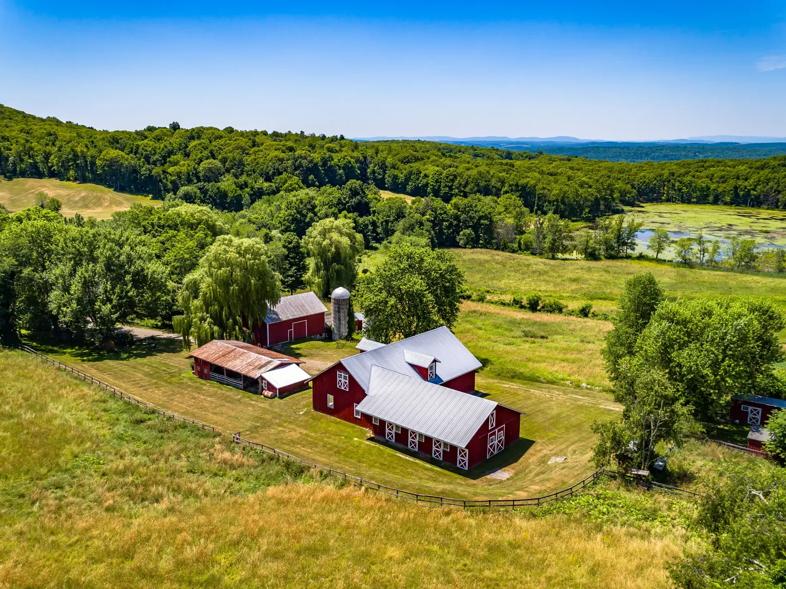 For $1.95M, this 66-acre upstate farm comes with a rustic party barn and a private swimming hole