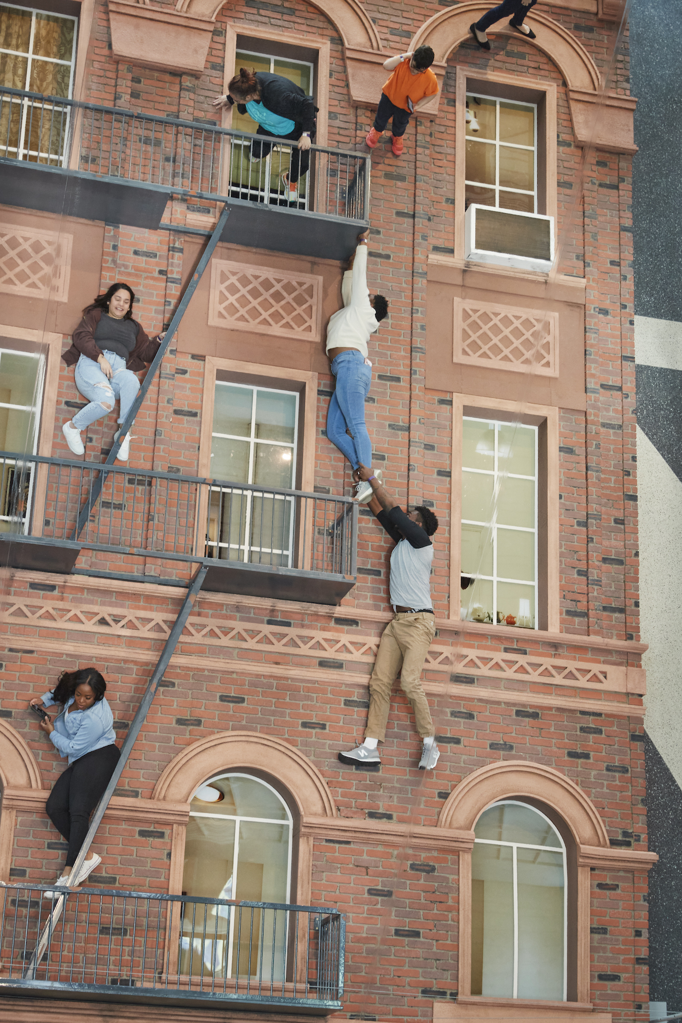 This art installation makes it look like visitors are climbing a