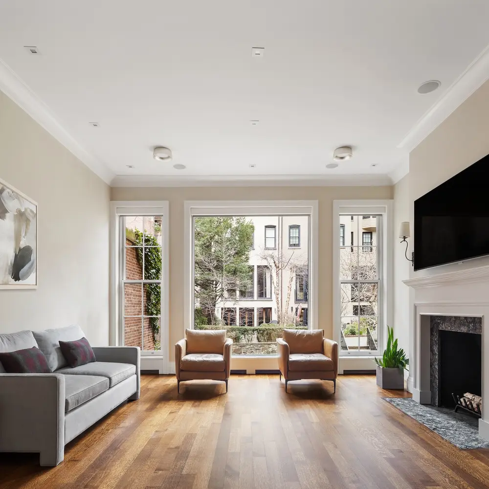 Take the elevator from the gym and English garden to the roof terrace in this $13.5M UES townhouse