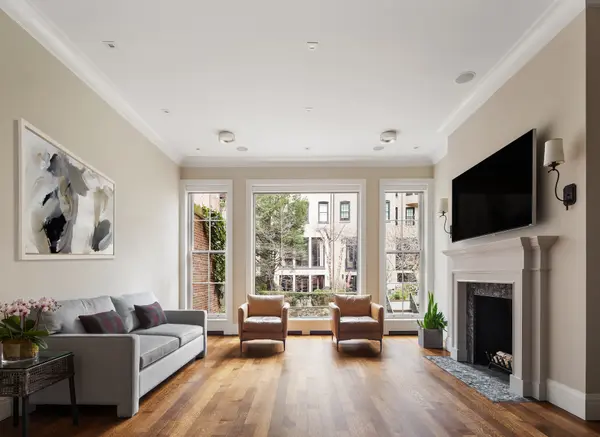 Take the elevator from the gym and English garden to the roof terrace in this $13.5M UES townhouse