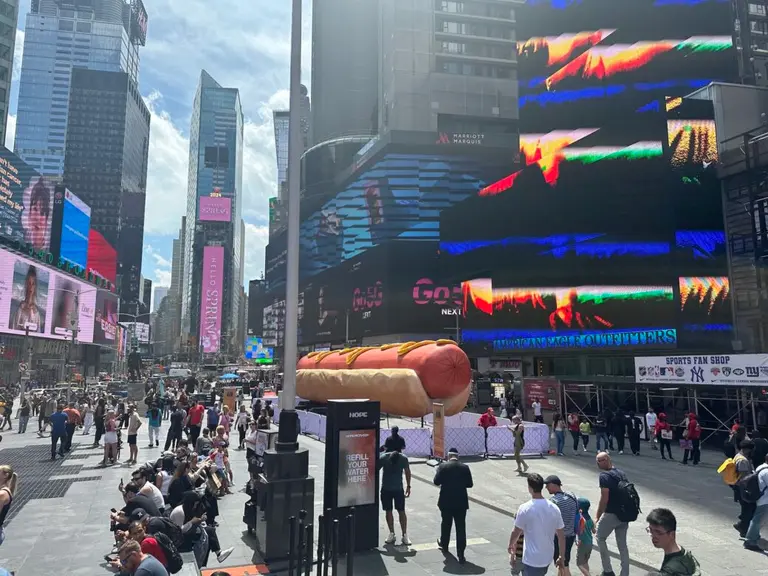 A giant, confetti-shooting hot dog is now on view in Times Square