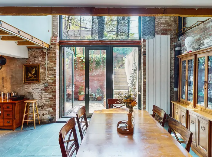 Asking $2.5M, this unusual Brooklyn condo feels like an artist's loft inside a rustic farmhouse