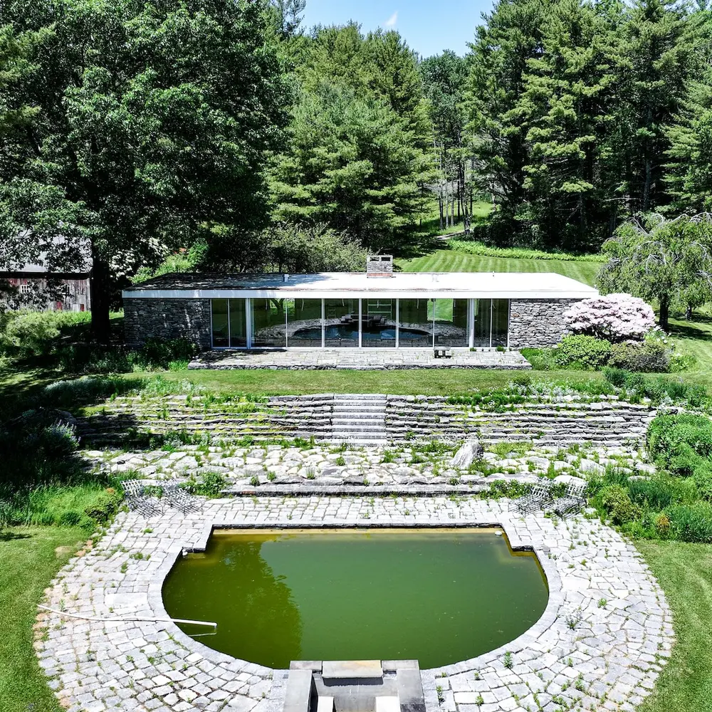 This 1969 stone-and-glass modern house on 25 Connecticut acres is a 'fire sale' listing for $1.3M