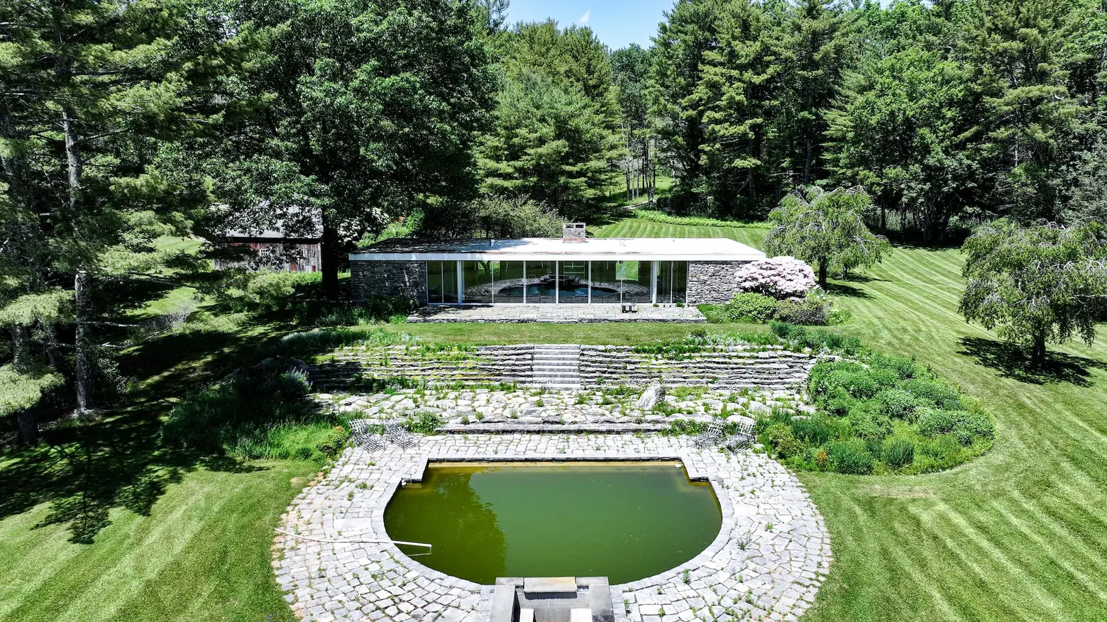 This 1969 stone-and-glass modern house on 25 Connecticut acres is a ‘fire sale’ listing for $1.3M